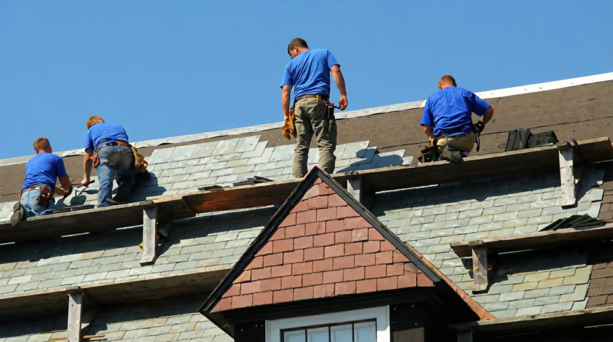 Roof replacement in progress with a team of professional contractors installing new shingles on a residential home in Bradenton, FL